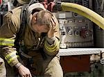 Fire fighter in uniform scratching his head