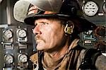 Portrait of a firefighter in front of control panel