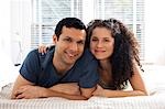 Man and woman on bed snuggling