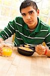 Boy and girl eating breakfast