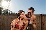 Man embracing woman in bikini smiling