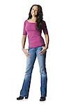 Woman in blue jeans standing with arms crossed