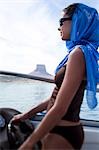 Woman on boat with headscarf and sunglasses