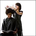 Female hairdresser cutting hair