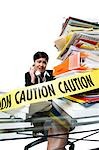 Woman with stack of binders and paperwork