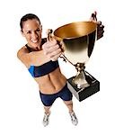 Woman athlete holding medal and making hand gesture