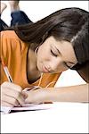 Teenage girl writing in notebook