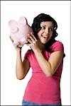 Teenage girl with piggy bank