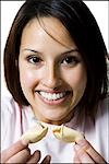 Woman opening a fortune cookie