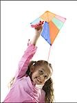 Young girl flying a kite