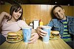 Portrait of a young man and a teenage girl sitting in a restaurant