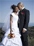 Newlywed couple standing together with their eyes closed