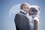Profile of a newlywed couple kissing each other