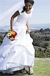 Portrait of a bride holding a bouquet of flowers and smiling