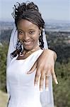 Portrait of a bride showing her wedding ring and smiling