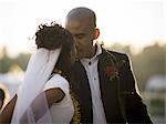 Close-up of a bride and groom kissing