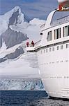 The mountains of the Livingstone Range and island at the stern of the MV Discovery during a landing at Half Moon Bay in Antarctica.