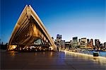 The Guillaume at Bennelong restaurant housed in an atrium of the Opera House with a backdrop of central Sydney