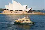 A Sydney ferry cruises past the Opera House toward the wharf at Circular Quay