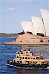 A passenger ferry heads out of Sydney Cove past the Opera House