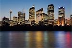 The lights of the central Sydney skyline are reflected in the waters of Farm Cove on Sydney harbour