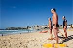 Members of the Bondi Surf Bathers Life Saving Club stand at the ready for a training rescue with traditional reel and line