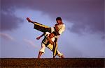 Deux garçons pratiquent la Capoeira, l'art martial brésilien.