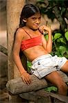 Young girl relaxing agianst a pole in the village of Maguari on the banks of the Tapajos river,a tributary of the Amazon River in the Amazonas Region of Brazil