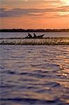 Brazil,Amazon,Rio Tapajos. A tributary of the Rio Tapajos which is itself a tributary of the Amazon. Sunset on the river and some fishermen take in the last catch.