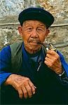 A Naxi man smokes his pipe