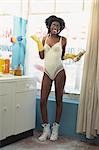 Woman wearing Lingerie and holding Cleaning Supplies