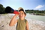 boy looking through a telescope