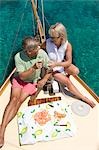 A senior couple picnic while sailing