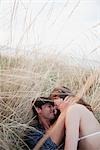 couple lying in reed embracing