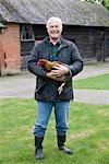 Farmer holding chicken