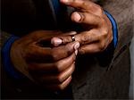 Business man putting on wedding band