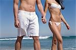 Couple Holding Hands on the Beach