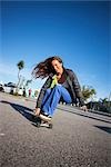 Woman Skateboarding on the Boardwalk, Santa Cruz, California, USA