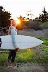 Surfer on Her Way to Steamers Lane in Santa Cruz, California, USA