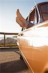 Woman's Feet Sticking Out the Window of a Vintage Car, Santa Cruz, California, USA