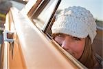 Woman Peeking Out the Window of a Vintage Car, Santa Cruz, California, USA