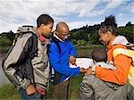 family hiking looking at map