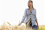 Woman walking in a wheat field