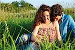 Couple sitting in a wheat field