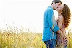 Couple kissing in a wheat field