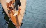 Feet of middle aged couple on old boat