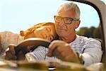 Couple in car, her head on shoulder