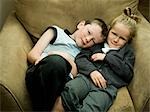 A brother and sister in an arm chair