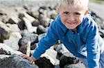 Boy sitting on stones