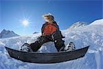 Snowboarder sitzend im Schnee, Zugspitze, Bayern, Deutschland